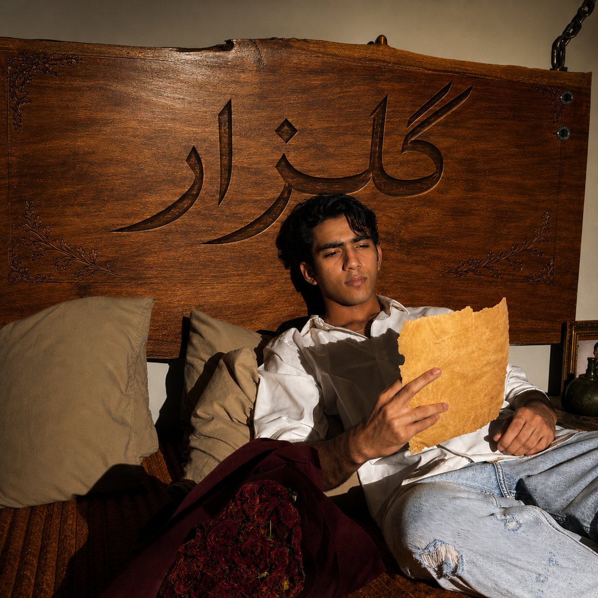 Abdullah Bilal reading a letter beneath a carved wooden headboard, from the Gulzaar artwork